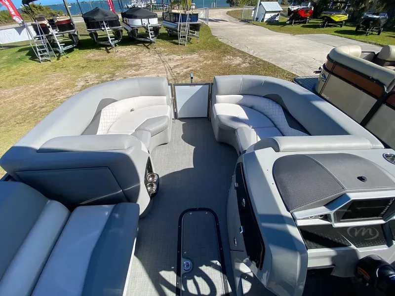Slide: The Image of 2022 Manitou 23 Encore RF VP pontoon boat interior with spacious seating. - 11