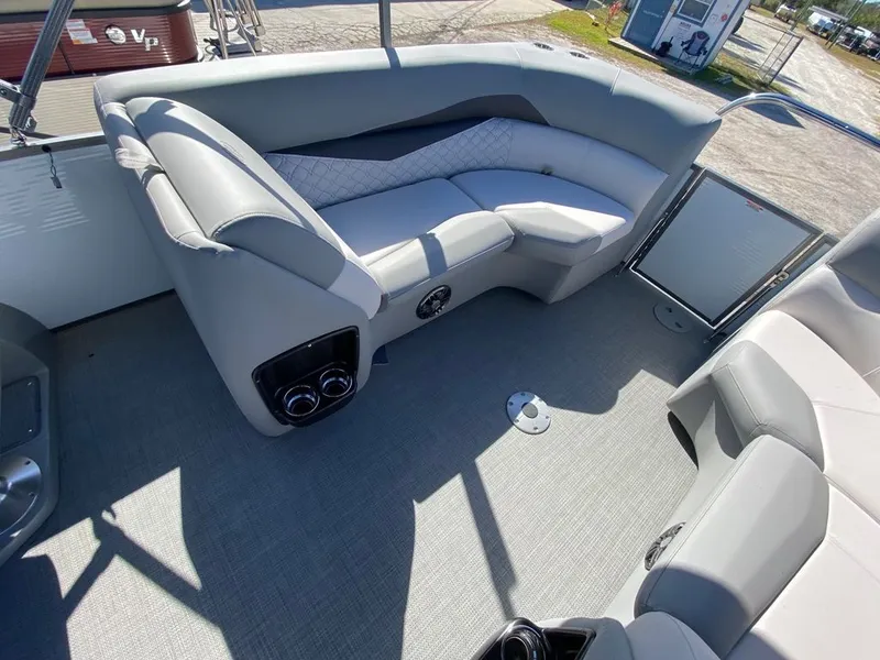 Slide: The Image of 2022 Manitou 23 Encore RF VP boat interior with grey seating and flooring. - 15