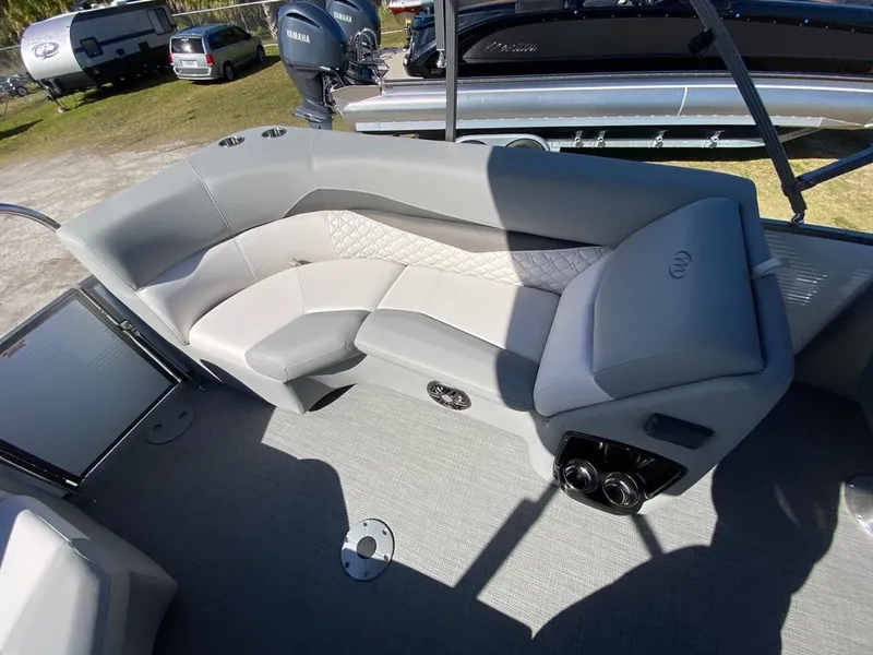 Slide: The Image of 2022 Manitou 23 Encore RF VP boat interior with gray and white seating. - 16