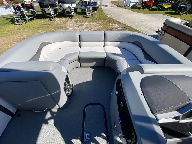 Slide: The Image of 2022 Manitou 23 Encore RF VP boat interior with spacious seating and modern design. - 17