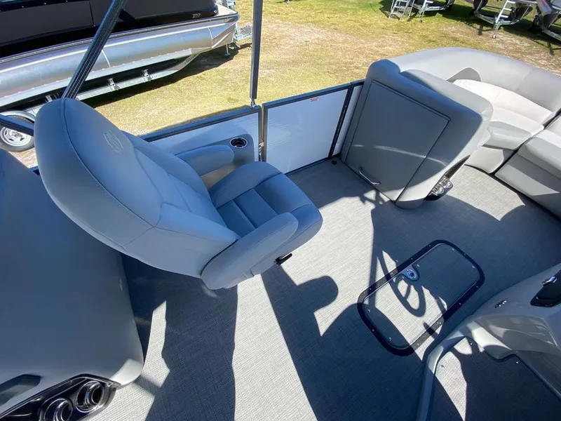 Slide: The Image of 2022 Manitou 23 Encore RF VP boat interior with gray seating and flooring. - 18