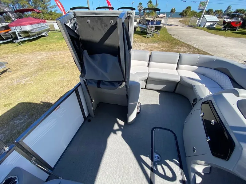 Slide: The Image of 2022 Manitou 23 Encore RF VP pontoon boat interior with spacious seating and modern design. - 19