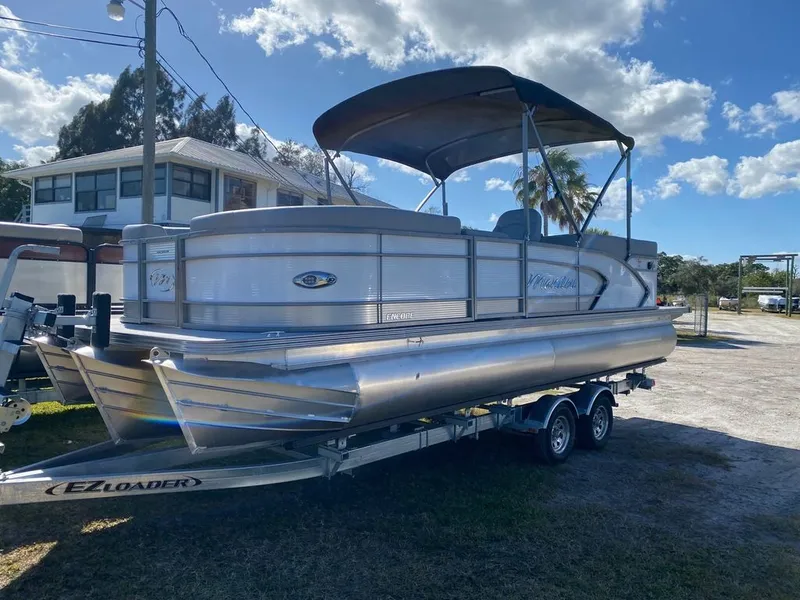 Slide: The Image of 2022 Manitou 23 Encore RF VP pontoon boat on EZ Loader trailer. - 2