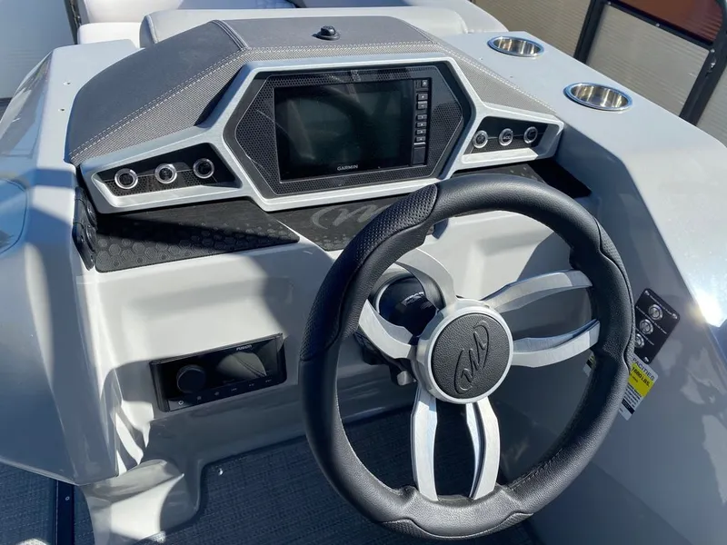 Slide: The Image of 2022 Manitou 23 Encore RF VP boat dashboard with steering wheel and Garmin display. - 21