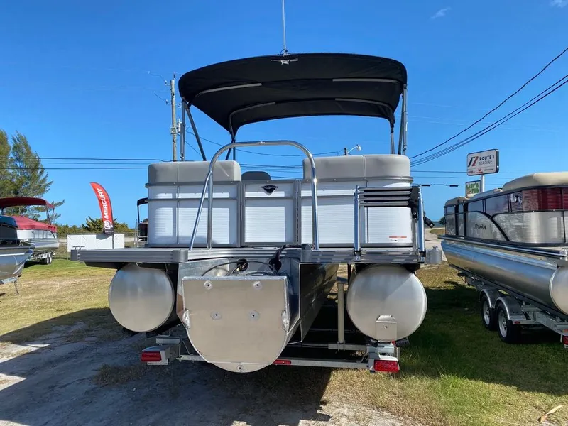 Slide: The Image of 2022 Manitou 23 Encore RF VP pontoon boat displayed outdoors. - 5