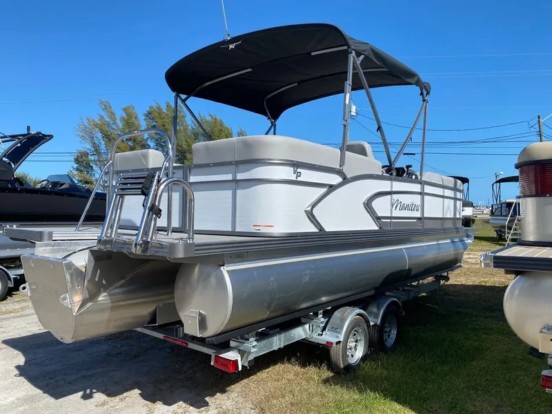 Slide: The Image of 2022 Manitou 23 Encore RF VP pontoon boat on a trailer. - 6