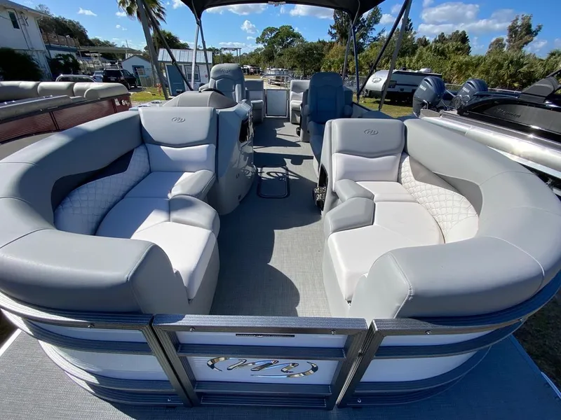 Slide: The Image of 2022 Manitou 23 Encore RF VP pontoon boat with luxurious seating. - 9