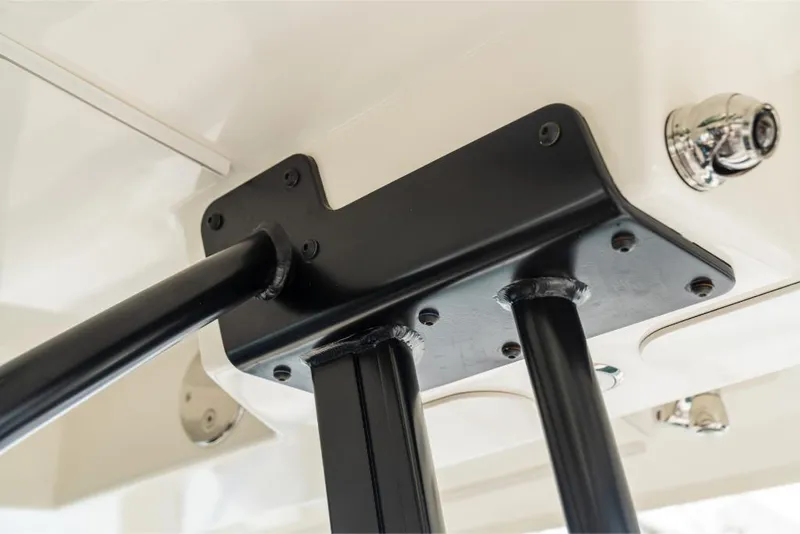 Slide: The Image of Close-up of the 2023 Boston Whaler 360 Outrage boat's sturdy black metal support structure. - 19