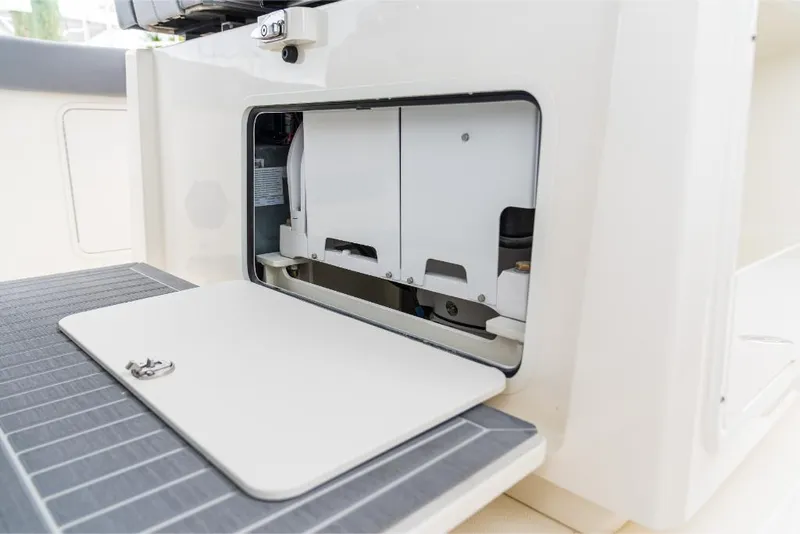 Slide: The Image of 2023 Boston Whaler 360 Outrage storage compartment with open hatch. - 20