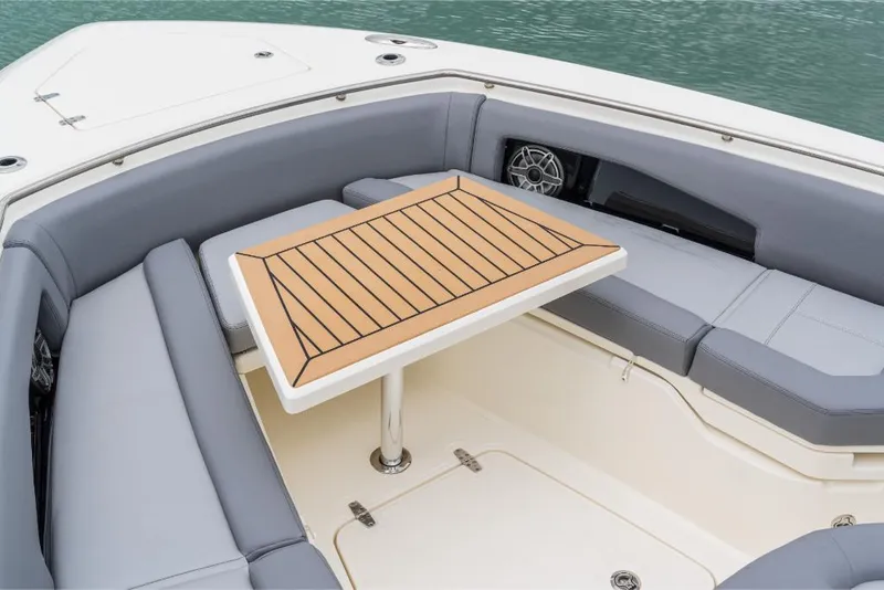 Slide: The Image of 2023 Boston Whaler 360 Outrage boat seating area with table. - 23