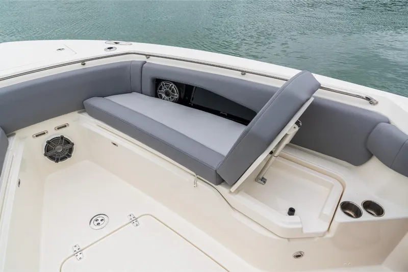 Slide: The Image of 2023 Boston Whaler 360 Outrage boat with cushioned seating and storage compartment. - 28