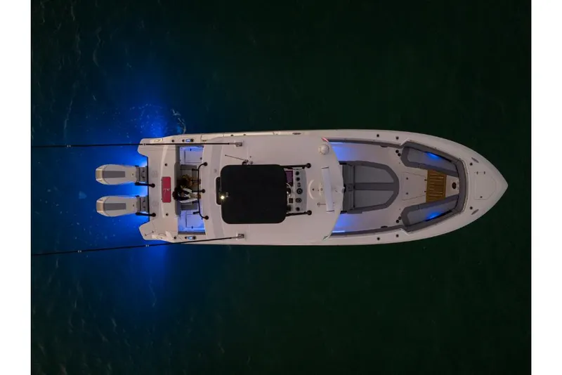 Slide: The Image of Top view of 2023 Boston Whaler 360 Outrage boat with blue LED lights. - 37