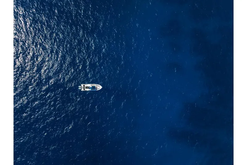 Slide: The Image of Aerial view of 2023 Boston Whaler 360 Outrage boat on deep blue ocean. - 43