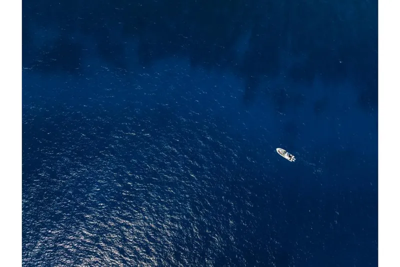 Slide: The Image of Aerial view of 2023 Boston Whaler 360 Outrage boat on deep blue ocean. - 45