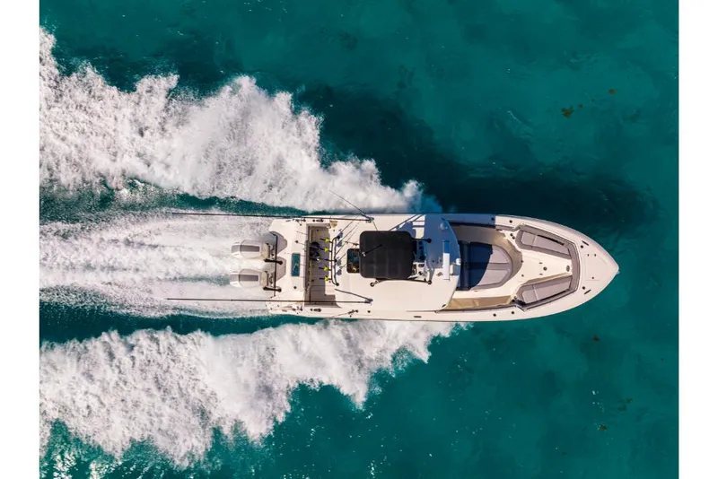 Slide: The Image of Aerial view of 2023 Boston Whaler 360 Outrage speeding on turquoise water. - 47