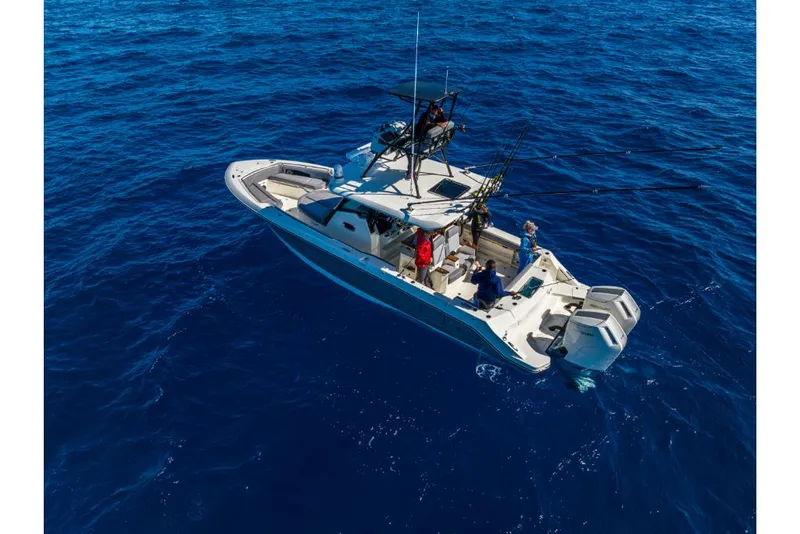 Slide: The Image of 2023 Boston Whaler 360 Outrage boat on open blue ocean. - 49
