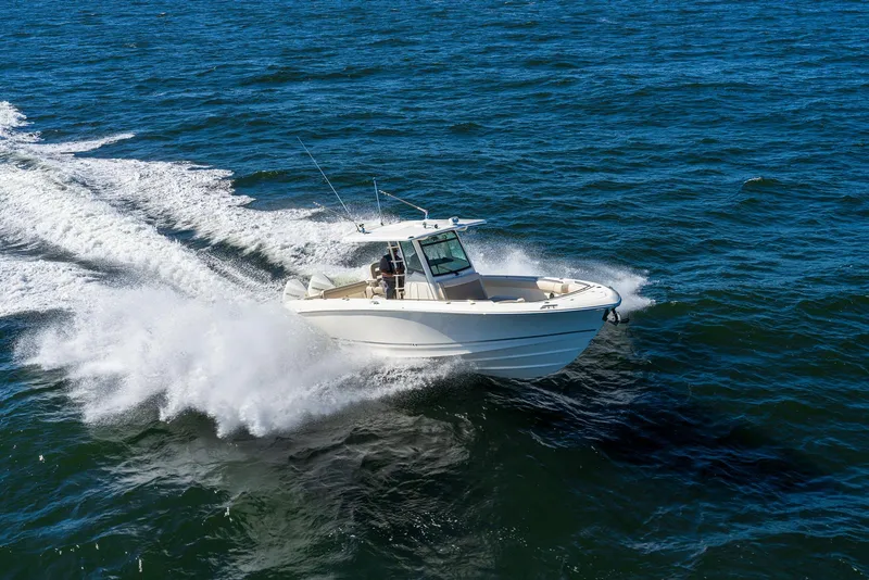 Slide: The Image of 2024 Boston Whaler 330 Outrage cruising on open water. - 12