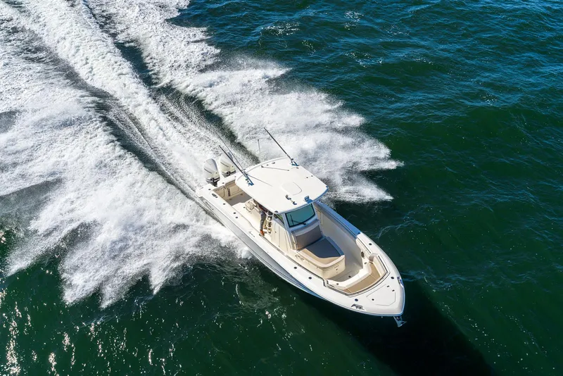 Slide: The Image of 2024 Boston Whaler 330 Outrage cruising on open water. - 13