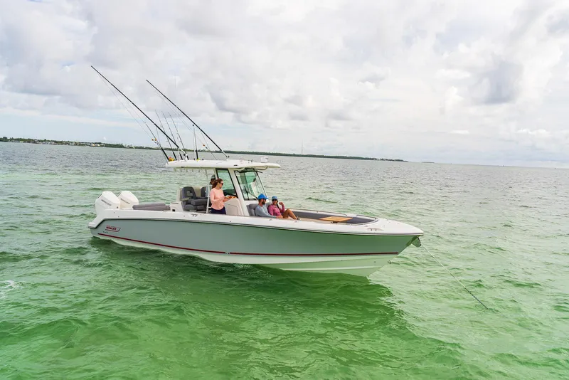 Slide: The Image of 2024 Boston Whaler 330 Outrage boat cruising on open water. - 20