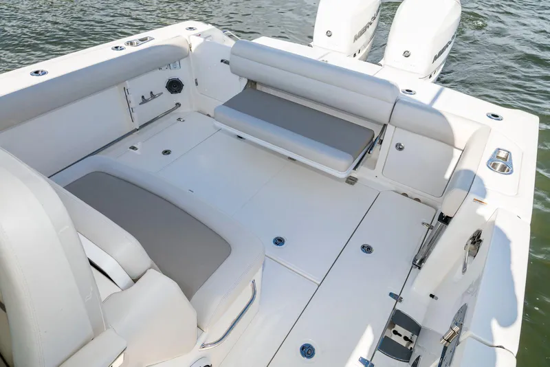Slide: The Image of 2024 Boston Whaler 330 Outrage boat interior with seating and storage. - 9