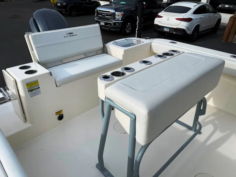 Slide: The Image of 2022 Cobia 220 CC boat interior with seating and cup holders. - 13