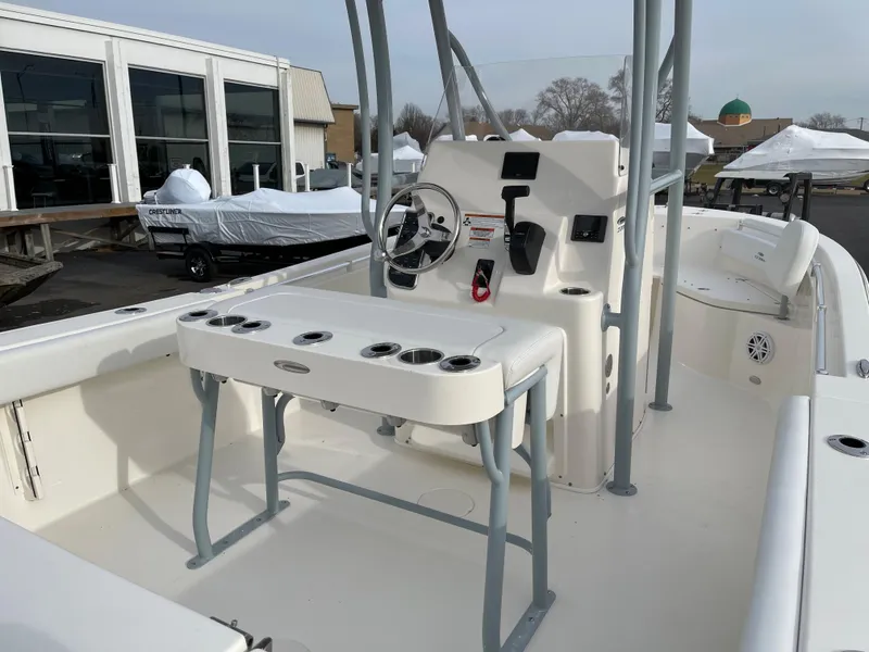 Slide: The Image of 2022 Cobia 220 CC center console boat interior with helm and seating. - 14