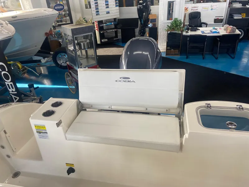 Slide: The Image of 2022 Cobia 220 CC boat interior with seating and storage compartments. - 22