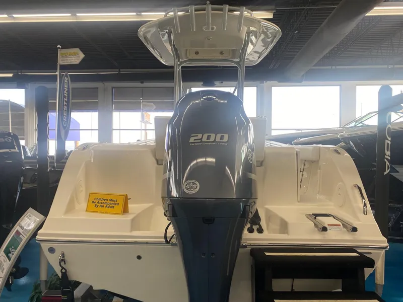 Slide: The Image of 2022 Cobia 220 CC boat with 200 HP engine displayed indoors. - 5
