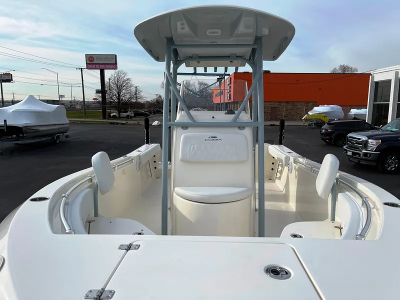Slide: The Image of 2022 Cobia 220 CC center console boat with seating and storage compartments. - 6