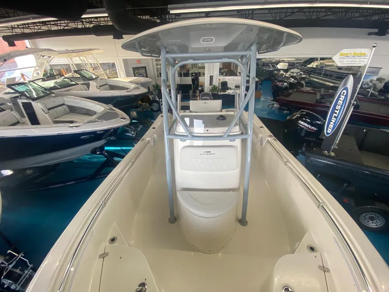 Slide: The Image of 2022 Cobia 220 CC center console boat displayed in a showroom. - 7