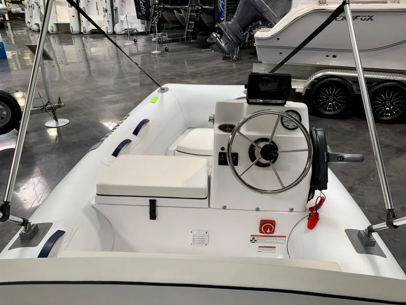 Slide: The Image of 2024 AB Inflatables 10 VSX boat interior with steering wheel and seating. - 3