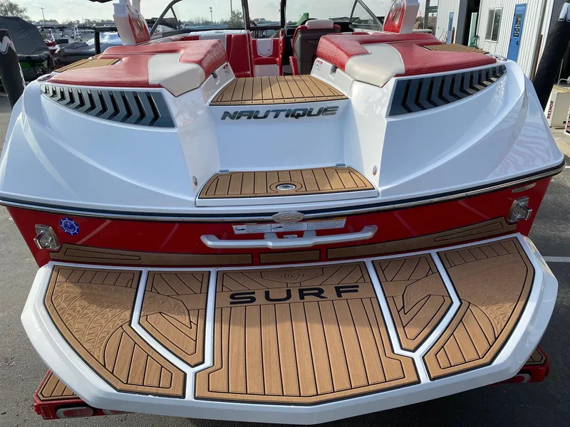 Slide: The Image of 2018 Nautique G23 boat with teak deck and red accents, designed for surfing. - 12