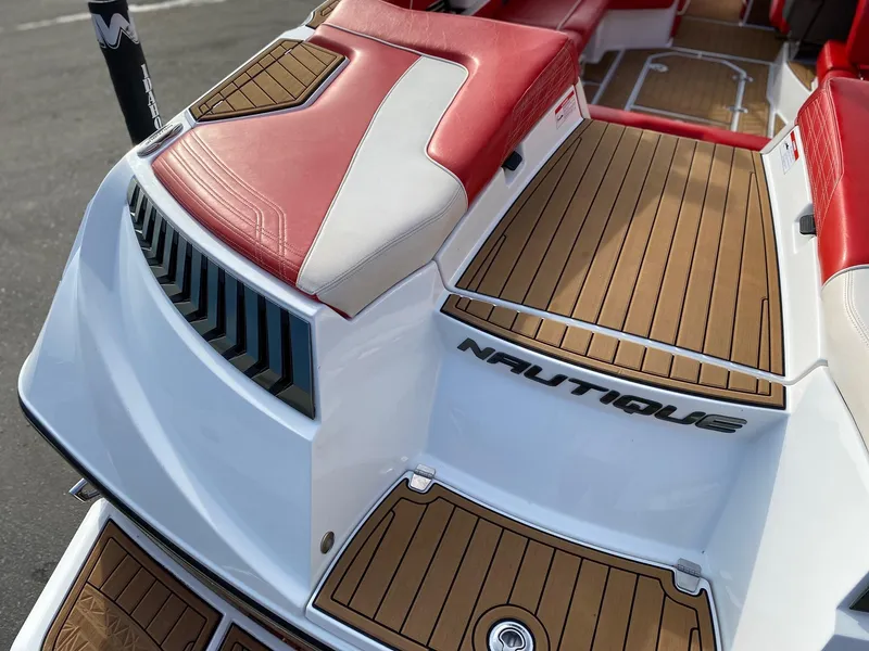 Slide: The Image of 2018 Nautique G23 boat with red and white seating, teak flooring. - 14