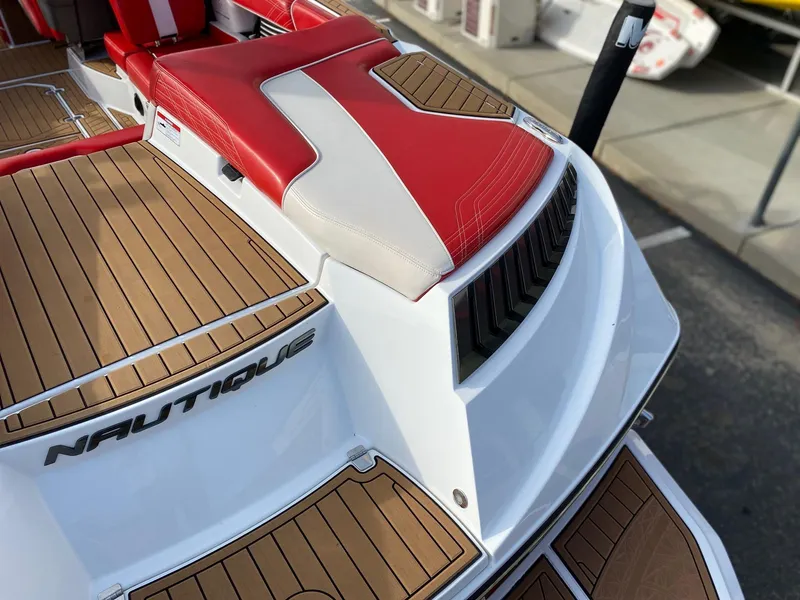 Slide: The Image of 2018 Nautique G23 boat with red and white seating, teak deck, and sleek design. - 15