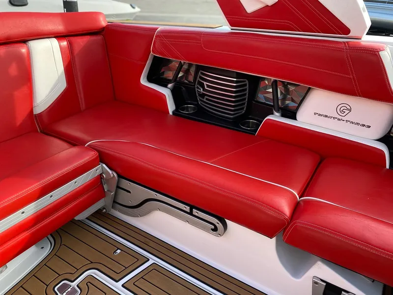 Slide: The Image of 2018 Nautique G23 boat interior with red leather seating and stylish design. - 20