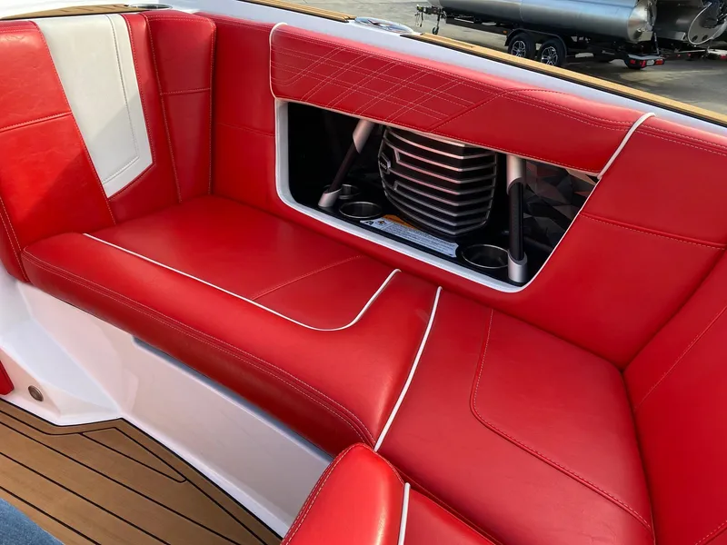 Slide: The Image of Red leather seating in a 2018 Nautique G23 boat interior. - 28