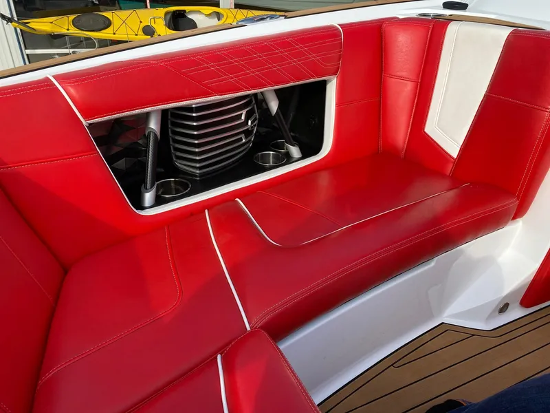 Slide: The Image of 2018 Nautique G23 boat with red and white seating, featuring stylish design and cup holders. - 29
