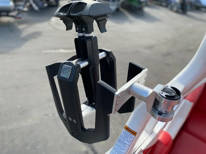 Slide: The Image of 2018 Nautique G23 wakeboard rack, mounted on a boat, with a sleek black and silver design. - 33