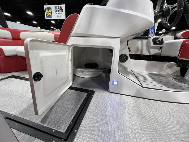 Slide: The Image of 2022 Montara SURF BOSS 23 boat interior with open storage compartment at a boat show. - 14