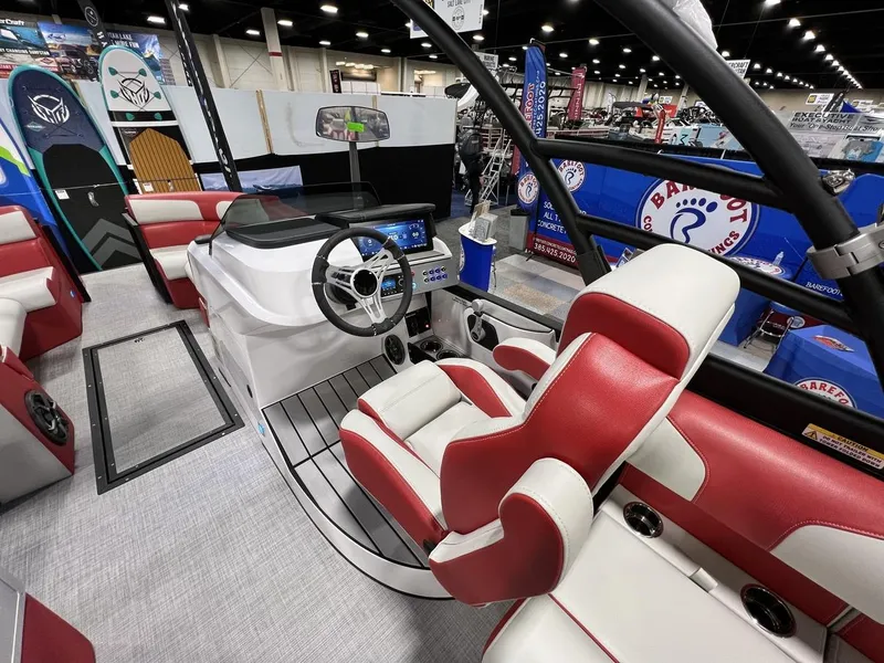 Slide: The Image of 2022 Montara SURF BOSS 23 boat interior with red and white seating at a boat show. - 16
