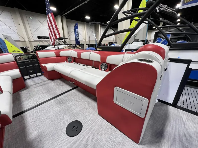 Slide: The Image of 2022 Montara SURF BOSS 23 boat interior with red and white seating at a boat show. - 18
