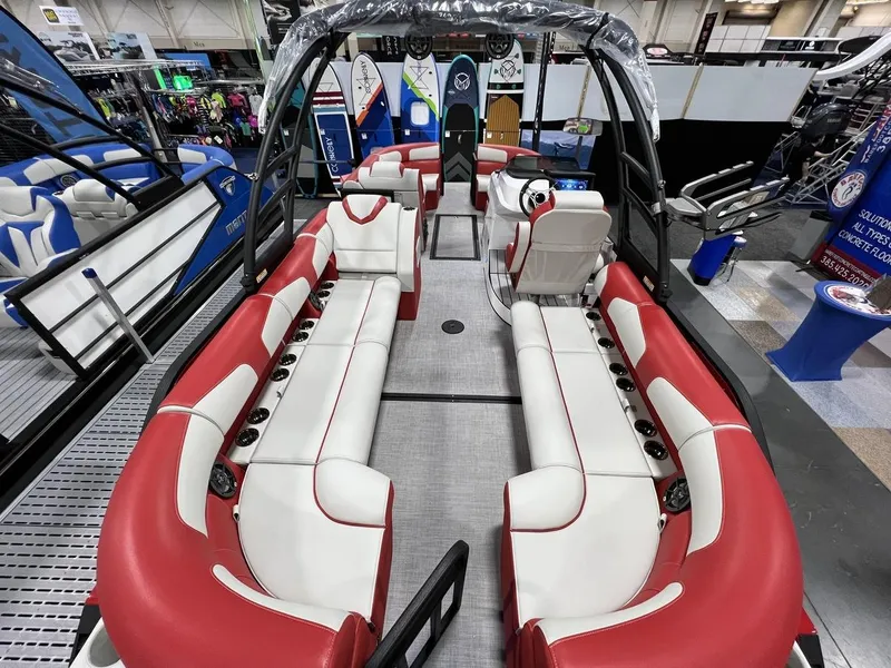 Slide: The Image of 2022 Montara SURF BOSS 23 boat interior with red and white seating at a showroom. - 19