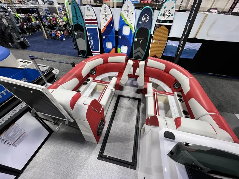 Slide: The Image of 2022 Montara SURF BOSS 23 boat interior with red and white seating, surfboards in background. - 23