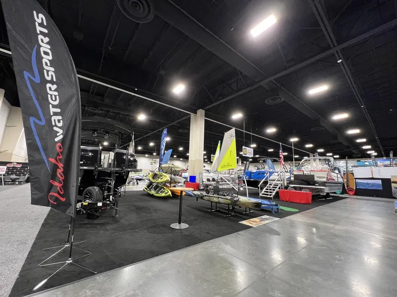 Slide: The Image of Indoor boat show featuring Montara SURF BOSS 23, Idaho Water Sports display, and various watercraft. - 25