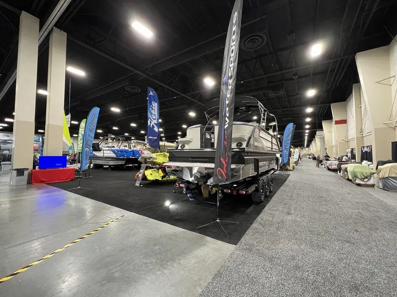 Slide: The Image of 2022 Montara SURF BOSS 23 boat displayed at an indoor exhibition with banners. - 26