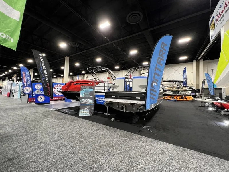 Slide: The Image of 2022 Montara SURF BOSS 23 displayed at a boat show with promotional banners. - 29
