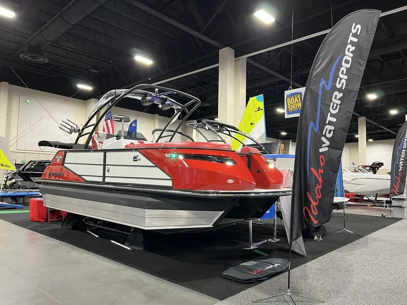 Slide: The Image of 2022 Montara SURF BOSS 23 boat displayed at a boat show with Idaho Water Sports banner. - 4