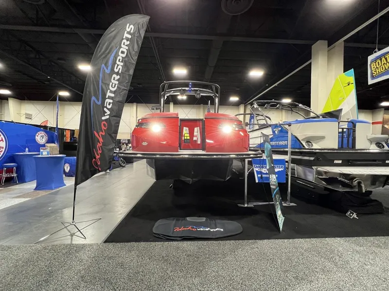 Slide: The Image of 2022 Montara SURF BOSS 23 boat displayed at Idaho Water Sports booth, indoor exhibition. - 5