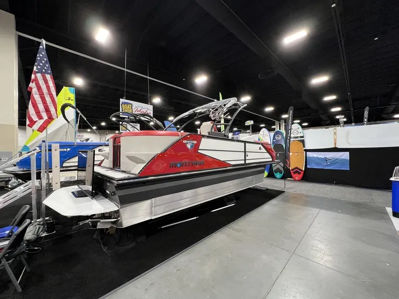 Slide: The Image of 2022 Montara SURF BOSS 23 boat displayed at an indoor exhibition with surfboards. - 6