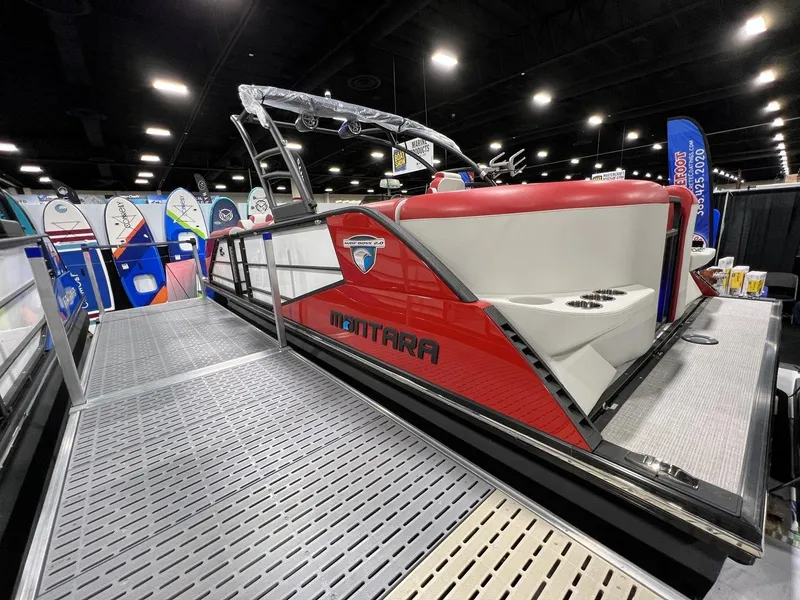 Slide: The Image of 2022 Montara SURF BOSS 23 boat displayed indoors, featuring sleek red and white design. - 8
